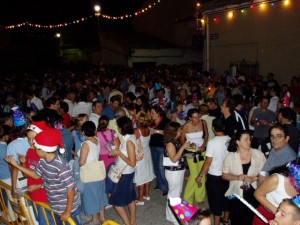 La gente se reune en la Plaza de la Iglesia, con sus uvas, su vino espumoso y su cotilln.